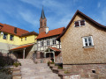 Nach der Neugestaltung: Treppenaufgang zu einem von Häusern umgebenen Häuser, über die der Kirchturm ragt